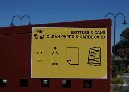 Bentleigh, VIC / Australia - Aug 29 2018: Bottles, cans, clean paper, and cardboard recycling bin...