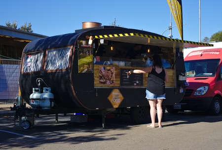 Frankston, VIC / Australia - Oct 13 2018: Woman pointing at menu at food truck