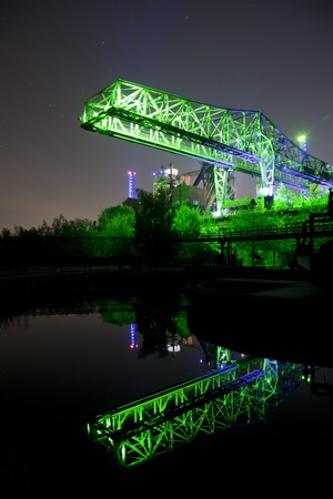 shot of industrial bridge in germany at night with reflection in waterの写真素材