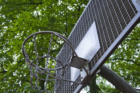 basketball hoop made out of metal with green trees on the backgoundのeditorial素材