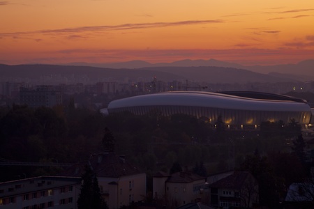 the city pf cluj napoca romania at sunset with the cluj arena football stadium on the backgroundのeditorial素材