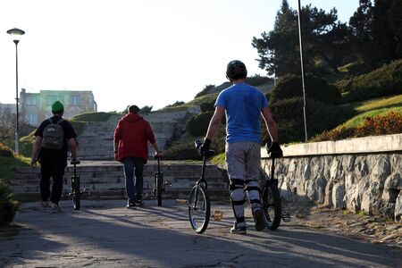 young men with monocycles in they hands のeditorial素材