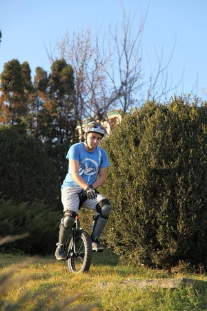 young man comming down a hill on a monocycleのeditorial素材