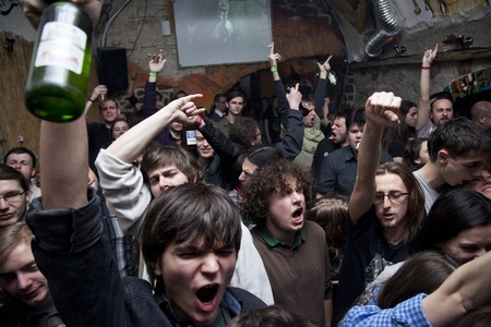 yound people in a crowd cheering at a concert in romaniaのeditorial素材