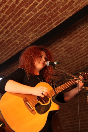 young woman playing guitar in a concert in romaniaのeditorial素材