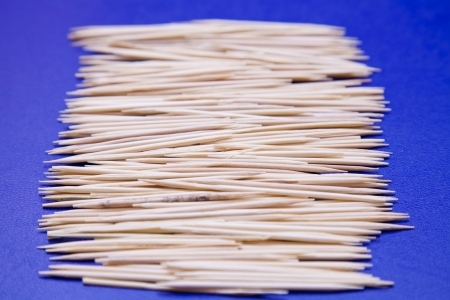 many wooden toothpicks on a blue backgroundの写真素材