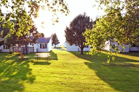 holiday house on green lawn with bright sunの写真素材