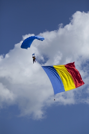 parachute skydiver with huge romanian flag hanging from himの写真素材