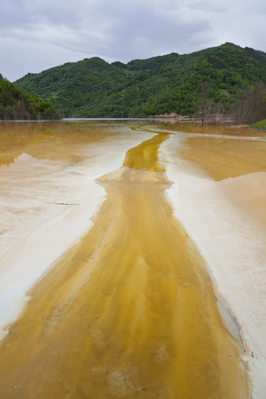 Poluted lake in the mountains from a mine in romaniaの写真素材