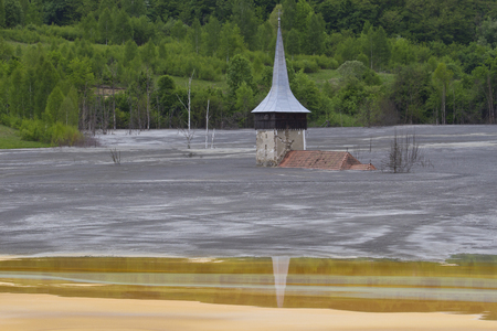 Flooded church in poluted mud lake in transilvaniaの写真素材
