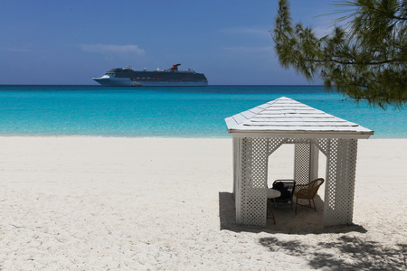 cruise ship close to a beach with a small relaxation buildingの写真素材
