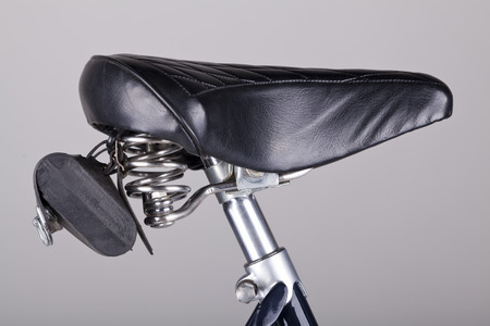 isolated bicycle seat with leather bag on greyの写真素材
