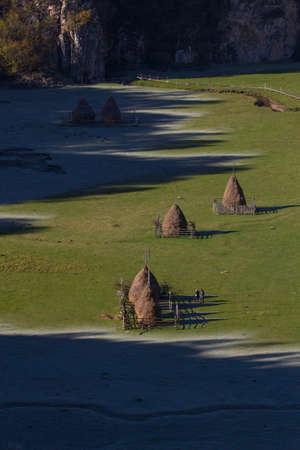 frozen haystacks at sunrise in valey from aboveの写真素材