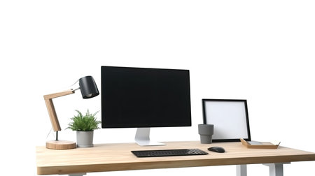 Modern workspace with computer monitor, keyboard, mouse, lamp and coffee cup on wooden desk isolated on white backgroundの素材