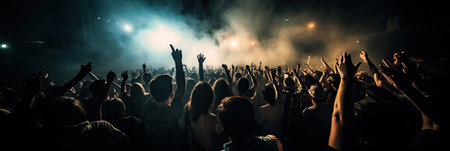 Crowd cheering at a music festival and raising their hands in the airの素材