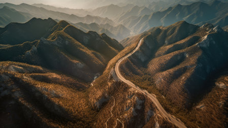 Beautiful mountain landscape with a winding road in the mountains at sunsetの素材