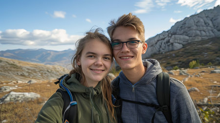Man and woman couple taking selfie on mountain together smiling.の素材
