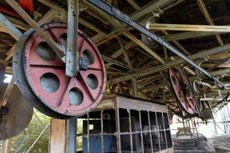 Steel metal wheel in industrial coal mining factory building with beams in Tormaleo Asturias province of Spain.の写真素材