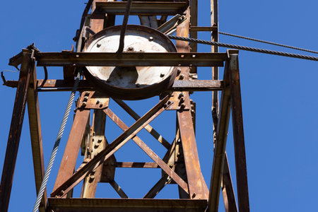 Detailed closeup of metal wheel with cable abandoned equipment for coal mining.の写真素材