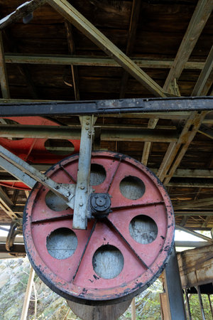 Steel metal wheel in industrial coal mining factory building with beams in Tormaleo Asturias province of Spain.の写真素材