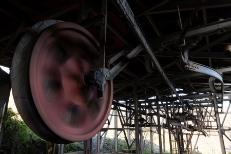 Closeup of rusty metal wheel from industrial mining equipment in abandoned coal factory.の写真素材