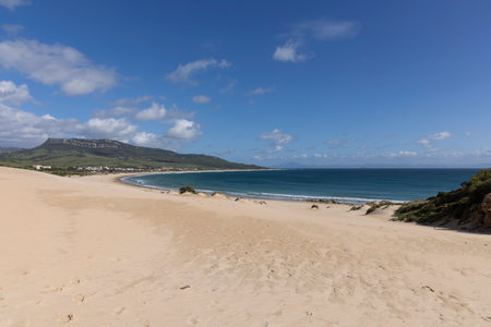Ocean landscape with sea and beach in Punta Paloma in Spain on a bright sunny day with clouds.の写真素材