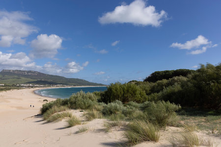 Ocean landscape with sea and beach in Punta Paloma in Spain on a bright sunny day with clouds.の写真素材