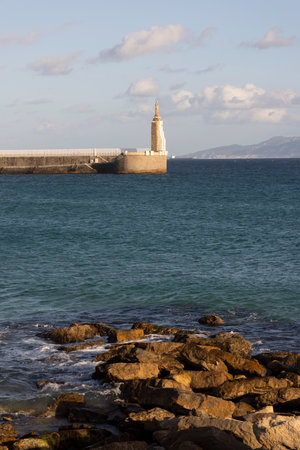 Vertical landscape of Sagrado corazon de Jesus landmark statue in Tarifa on the shore of the Atlantic ocean Girraltar Strait on a bright sunny day with clouds in the bacgkorund.の写真素材