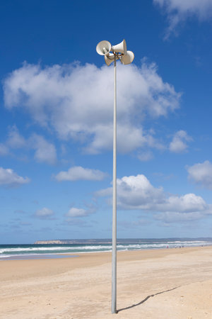 Beach megaphone speaker siren on a sunny day with bright blue sky and clouds.の写真素材