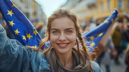 Closeup portrait of young caucasian woman  holding european union symbol flag after in national government democracy euro campaignの素材