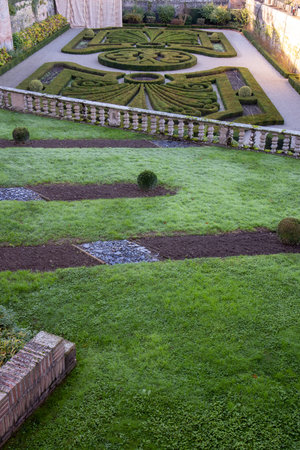 An aerial view of a finely manicured garden displays intricate geometric patterns, showcasing the beauty of nature and human artistry in landscape design.の写真素材