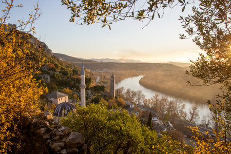 A panoramic autumn view highlights a historic landscape, blending ancient structures with vibrant colors and a winding river that inspires exploration and reflection.の写真素材