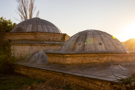 A close-up view of elegantly designed traditional domes, highlighted by the warm glow of the setting sun, illustrating architectural beauty and cultural richness.の写真素材