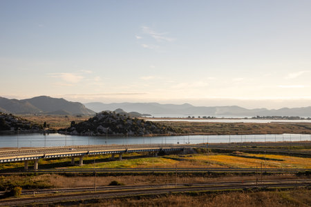 A captivating view of a winding waterway through a picturesque landscape, showcasing the beauty of nature's curves and the idyllic setting that invites exploration.の写真素材