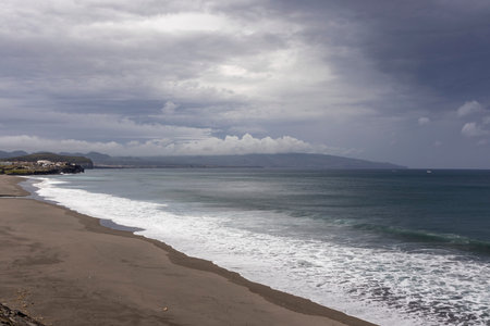 Azores, Portugal, October 8, 2025: A beach with a cloudy sky in the background. The sky is overcast and the beach is emptyのeditorial素材