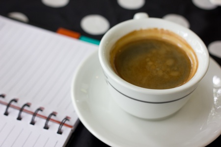 Hot coffee and note on tableの写真素材
