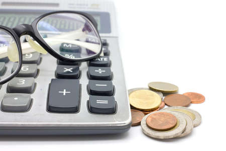 Coins and calculator  on white backgroundの写真素材