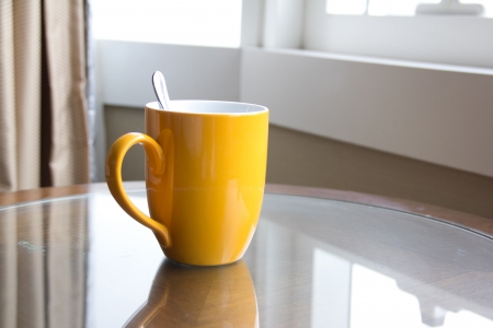 yellow coffee cup in officeの写真素材