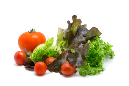 Fresh vegetables and green salad isolated on white の写真素材
