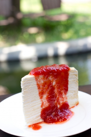 Strawberry crepe cake on white dish.の写真素材
