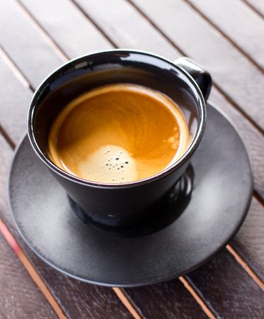 Cup of coffee on a wooden table,の写真素材