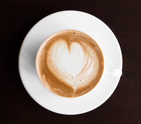 Hot cappuccino or latte coffee with heart shape.の写真素材