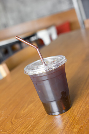 Delicious ice coffee americano on wood table.の写真素材