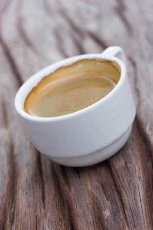 Cup of hot coffee on a wooden table in cafe.の写真素材