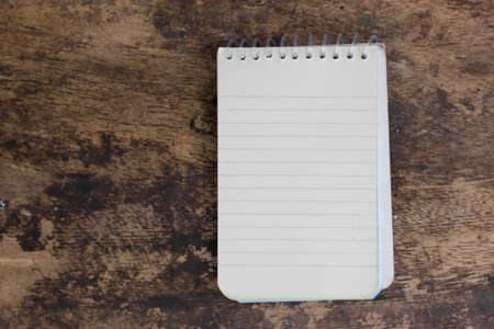 Open blank notebook on wood backgroundの写真素材