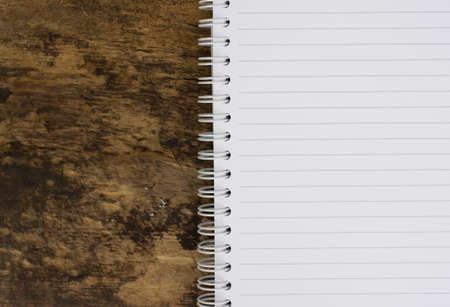 Open blank notebook on wood backgroundの写真素材