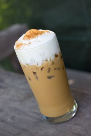 Iced coffee on a wooden table (Iced Cappuccino)の写真素材