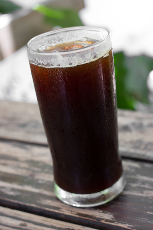 Delicious ice coffee americano on wood table.の写真素材