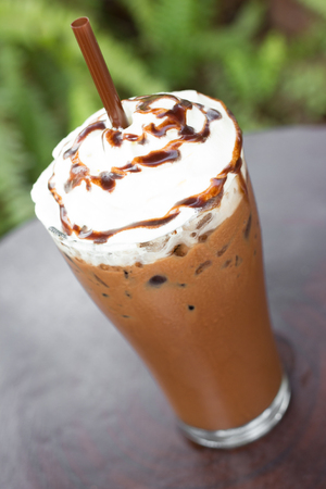 Ice chocolate with whipped cream on table.の写真素材