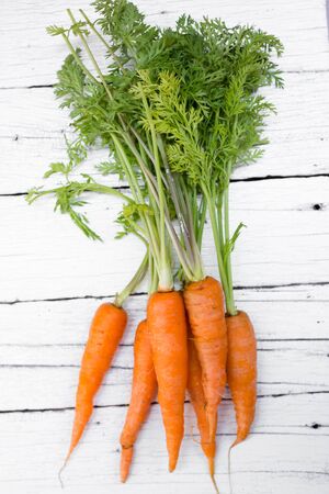 Fresh organic carrots , on a wooden table.の写真素材